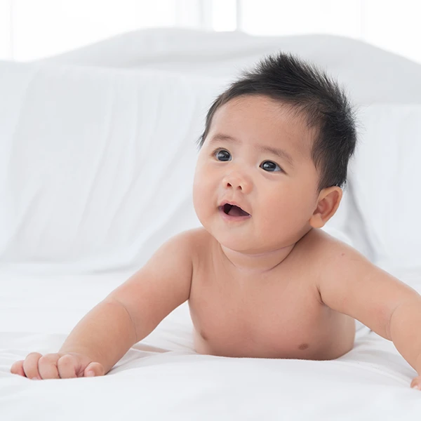 baby-boy-wearing-diaper-white-sunny-bedroom-best-baby-skin-care-products