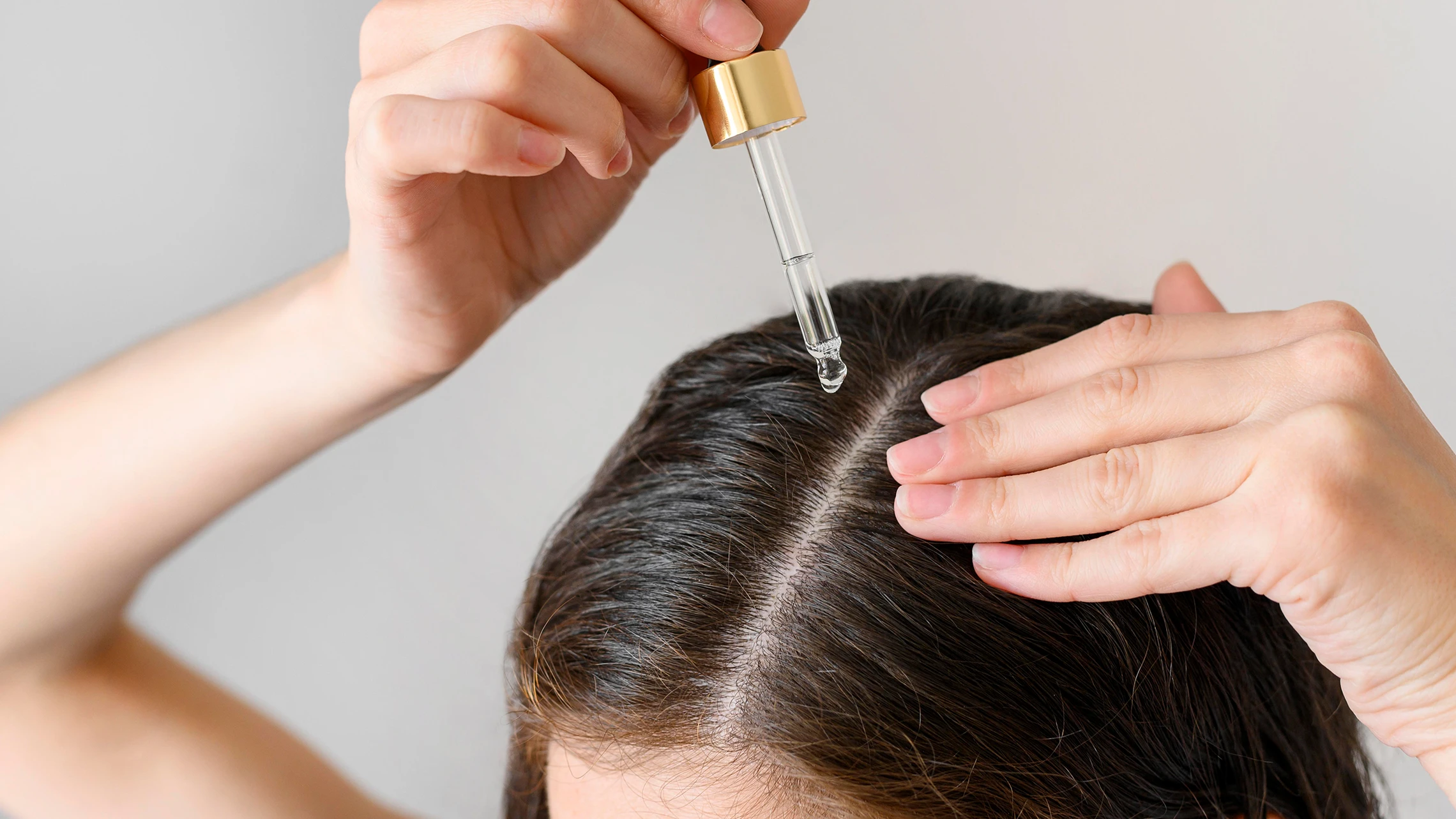 close-up-woman-applying-serum-scalp