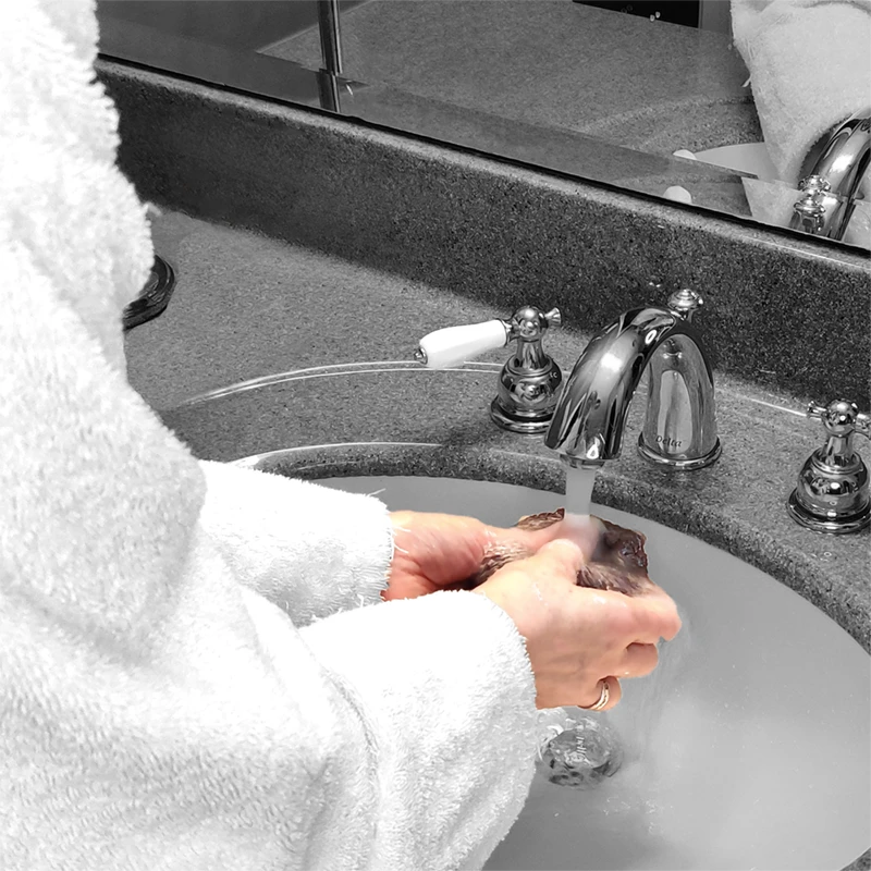 woman holding a cloth under running water