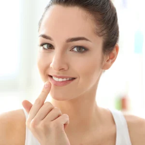 corum-lip-butter-tin-young-woman-touching-lips