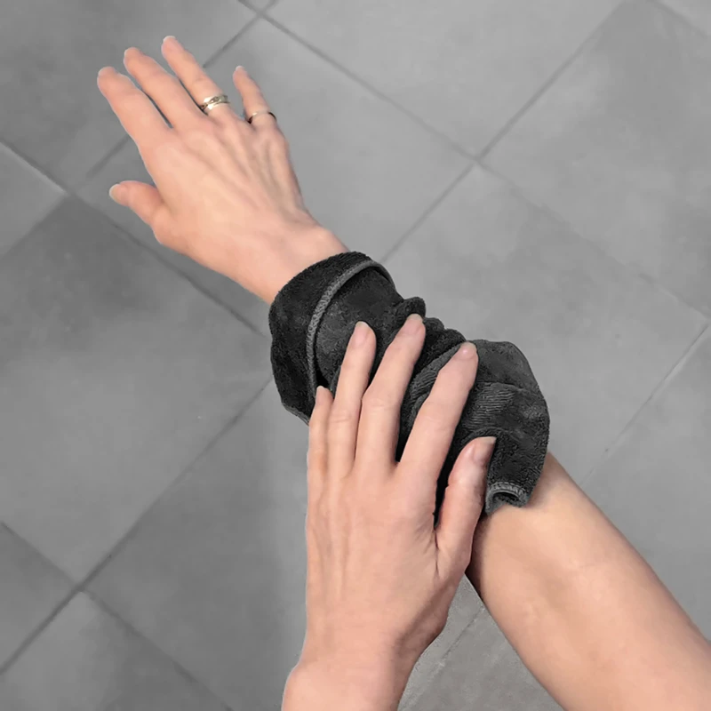 woman stroking her arm with a cloth and cleanser