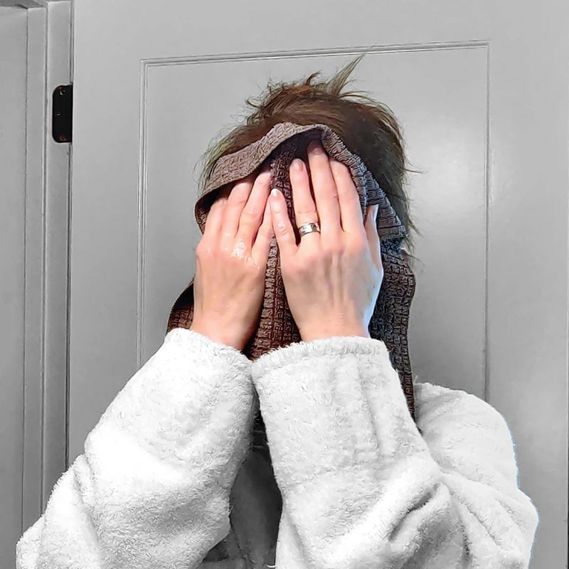 Woman holding a cloth to her face