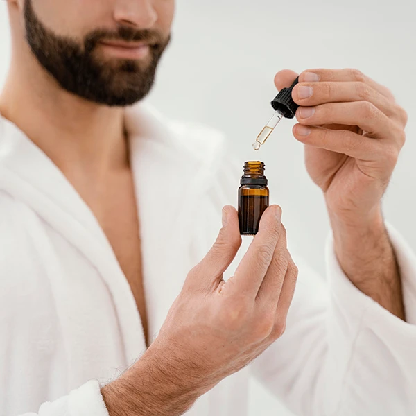 man-using-natural-oils-his-face-skin-care-for-dry-skin