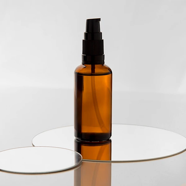 minimalist-skincare-amber-bottle-no-label-mirror-base