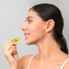 woman applying Corum Lip Butter to her lips